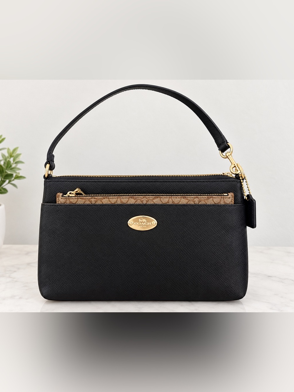 Coach leather shoulder bag with signature zip pouch
